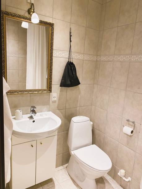 istock Contemporary bathroom featuring beige wall tiles 1936985127