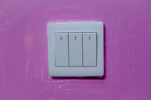 a light switch attached to the wall of the room