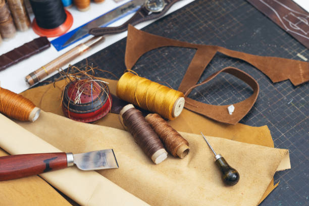 istock Tools and leather at cobbler workplace. Set of leather craft tools on wooden background. 1937018117