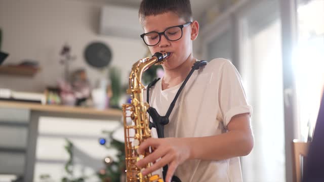 Boy learning to play saxophone