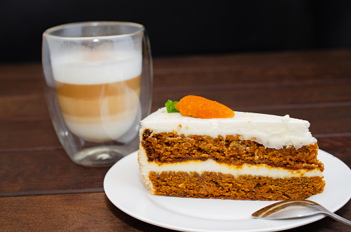 Carrot sponge cake with cream and walnuts and Cappuccino coffee. High quality photo