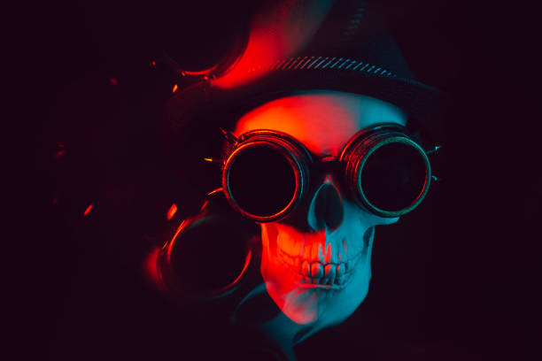 human skull in steampunk glasses and a hat with red and blue light on a dark background with reflection