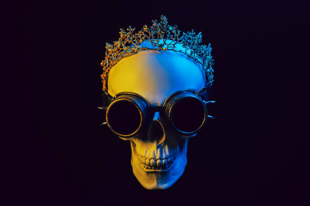 istock human skull in a crown and steampunk glasses with colored yellow blue neon light 1937047031