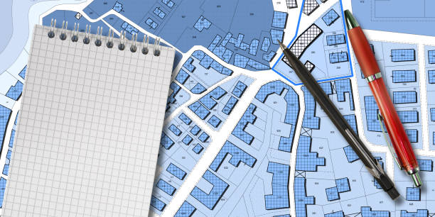 istock Imaginary cadastral map of territory with buildings, roads, land parcel and notepad with copy space 1937064812