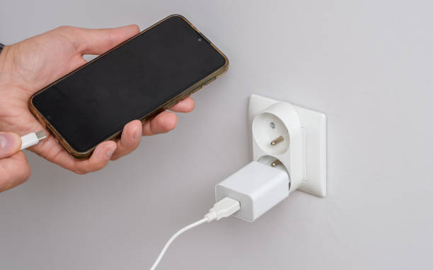 istock Connect a smartphone with a discharged, empty battery to the power supply 1937068152