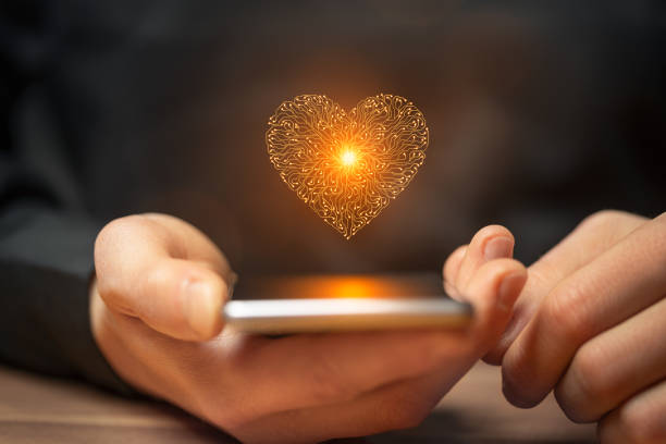 istock Artificial intelligence heart symbol on a smartphone held by a man over a table 1937086180