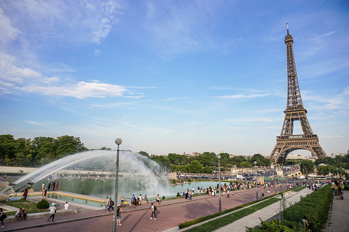 Europe, France, Paris, 2019-06, Eiffel Tower monument viewd from the Trocadero gardins. People bathing in the fountains in an effort to cool down during the heatwave.