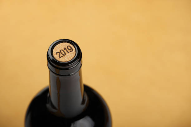 istock Bottle of white wine with cork on beige background 1937091008