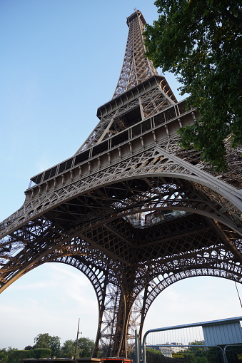 Paris, France - June 29, 2013: Parisian Street against Eiffel Tower on 29 June 2013 in Paris, France. The tower is the tallest structure in Paris and the most-visited paid monument in the world.