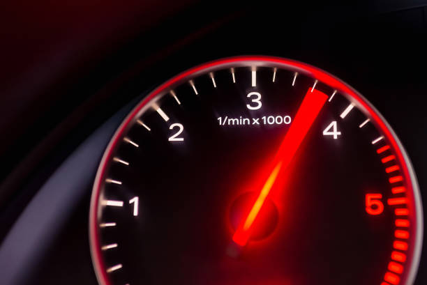 A speedo of a car begging to go faster. (it did, it did) focus on dials, steering out of focus