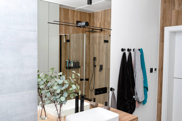 istock LED light strips mounted in the wall in a modern bathroom, visible black wall lamp. 1937093245