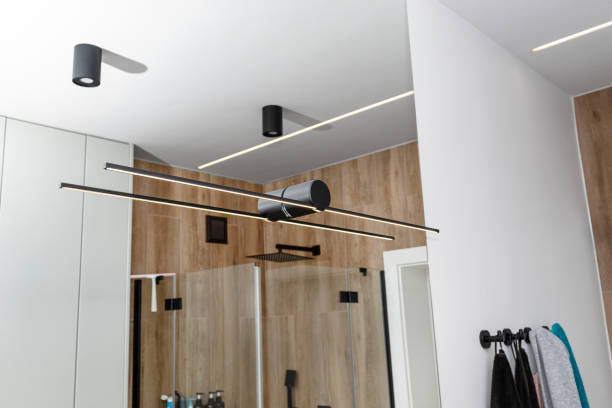 led light strips mounted in the wall in a modern bathroom, visible black wall lamp. - vidrio templado en baños fotografías e imágenes de stock