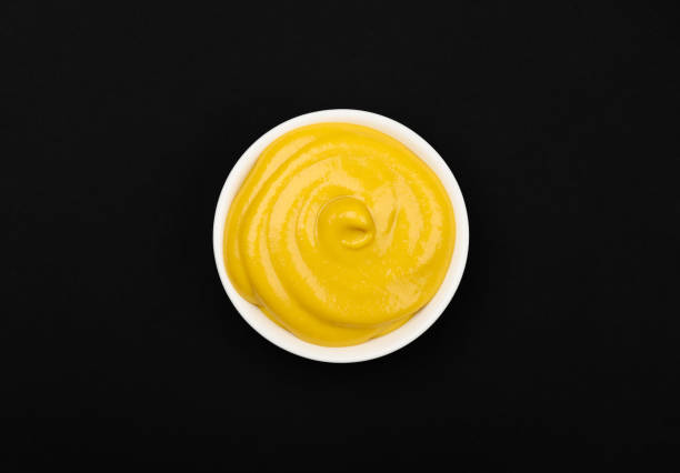 istock White bowl of yellow American mustard on table 1937103728