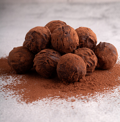 photo homemade dark chocolate truffles, a sweet and energy-packed dessert. of cocoa-coated treats, promising a rich and satisfying flavor experience. Indulge in this calorie-worthy of heavenly delights. closeup, gourmet, sugar, dessert - sweet food