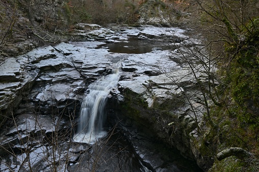 A view of the waterfalls on the river Clyde near New Lanark during winter in Scotland.