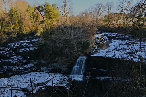 A view of the waterfalls on the river Clyde near New Lanark during winter in Scotland.