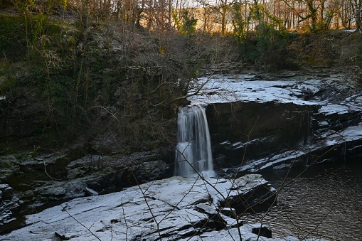 A view of the waterfalls on the river Clyde near New Lanark during winter in Scotland.