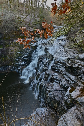 A view of the waterfalls on the river Clyde near New Lanark during winter in Scotland.