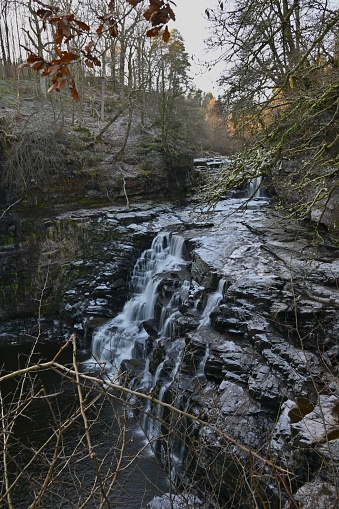 A view of the waterfalls on the river Clyde near New Lanark during winter in Scotland.