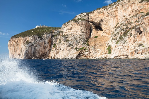 The blue of the sea in front of Capo Caccia is so intense against the shiny cliffs of the coast and the foam raised by the boat. The destination is the famous caves of Neptune.