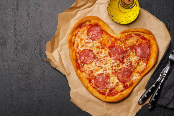 istock Heart-shaped pizza: Delicious love-themed dish 1937118402