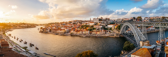 Panoramic view of the city of Oporto during sunset. Porto skyline. Magnificent sunset over downtown Porto and the Douro river, Portugal. The Dom Luis I bridge is a popular tourist spot as it offers beautiful views of the area.