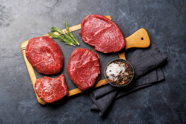 istock Raw beef fillet steaks on a cutting board, fresh and uncooked 1937123578