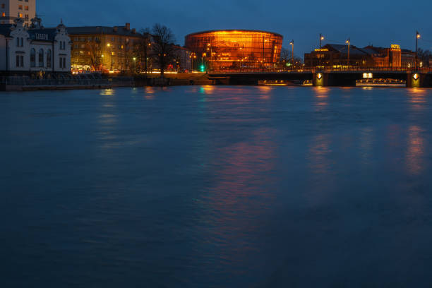 LATVIA, LIEPAJA - 18 FEBRUARY: Liepaja is a city located on the Baltic Sea. View to the coast of canal with red concert hall in night on 18 February 2022, Liepaja, Latvia.