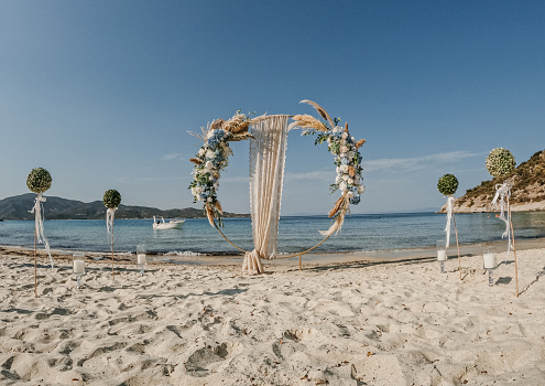 Beautiful wedding decorations on the beach by the sea.
