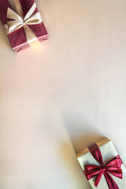 Love and romance greeting card, Valentines Day composition. Christmas concept. Top view of gift boxes on gold colored background with copy space.  Anniversary card. Dating. Flat lay