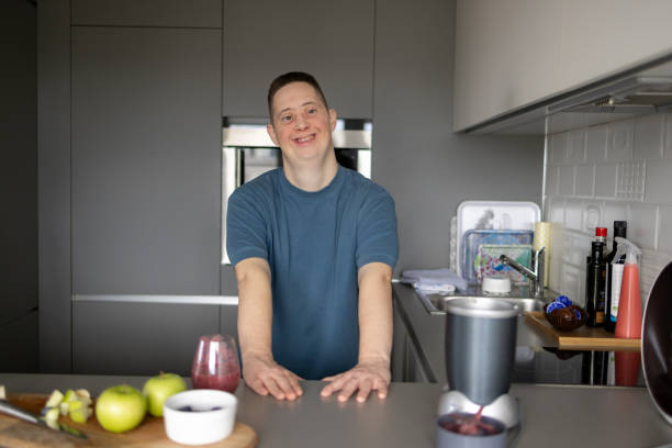 istock Happy man with special needs enjoying in the kitchen. 1937130995