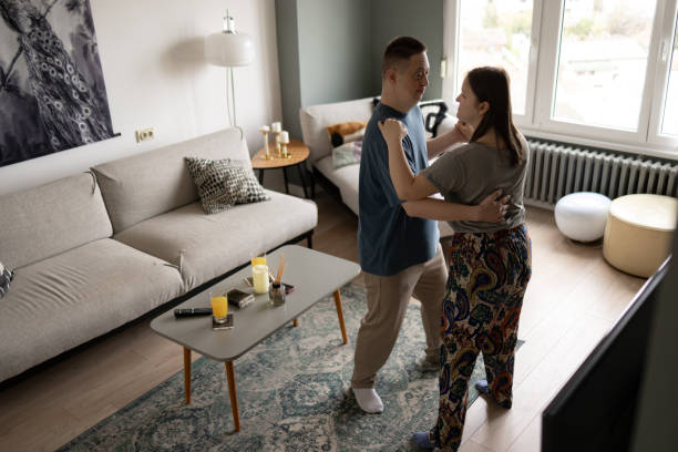 istock Carefree couple with special needs having fun while dancing in the living room. 1937135208