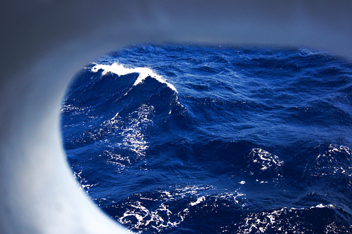 Breaking waves on dark blue sea.