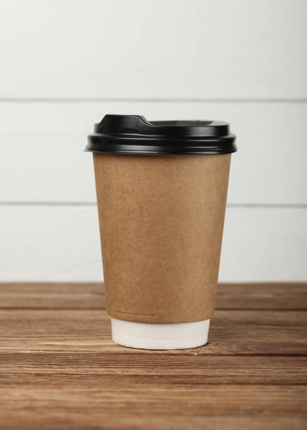 istock Brown paper coffee cup over white wall 1937158531