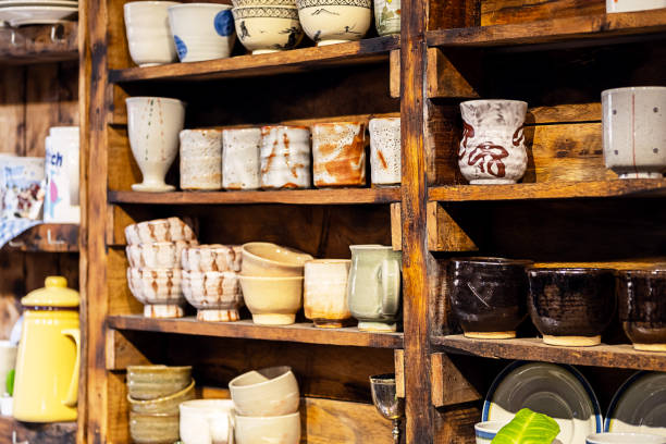 istock Multitude of handmade pottery shelves in small store. 1937165080