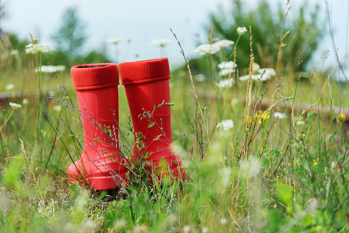 Red rubber boots on the abandoned railroad.