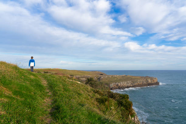 istock Boy walking along a cliff overlooking the sea 1937185698