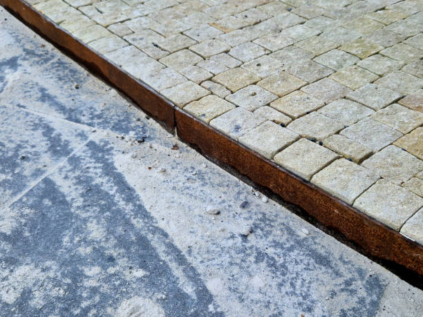 istock there is a metal sheet curb between the paving. Beige sandstone cube tiles. large format and small. separates the landscape park in the flowerbed 1937195052