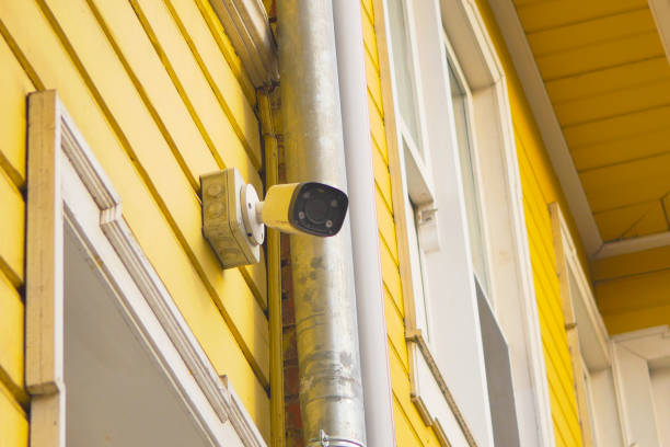 istock CCTV security camera operating on yellow color wooden building 1937195416