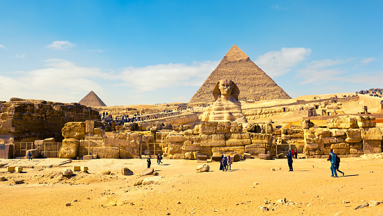 Architectural detail of the Giza pyramid complex located about 13 km southwest of the city center of Cairo. In the background, the Pyramid of Cheops (left), and the Pyramid of Chephren (right)