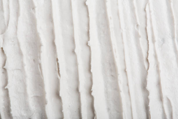 istock Structural plaster white on a black background. White Cream. paint smear. Plasticine 1937228670