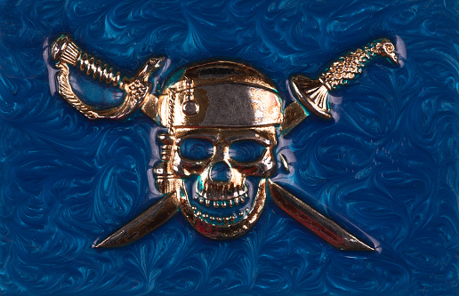 pattern of pirate skull with swords on blue background