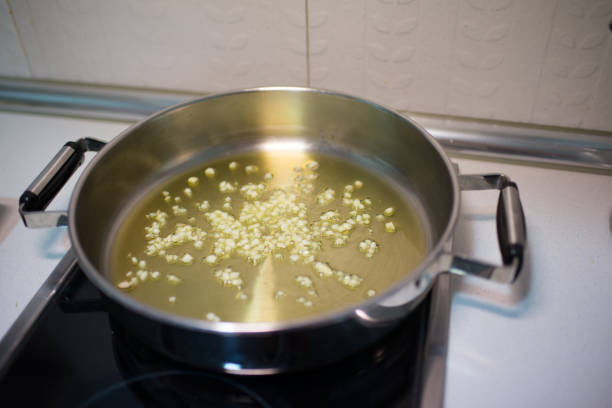 Cooking pot with oil and diced garlic. Domestic kitchen