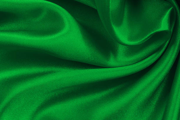 Green emerald fabric texture background, detail of silk or linen pattern.