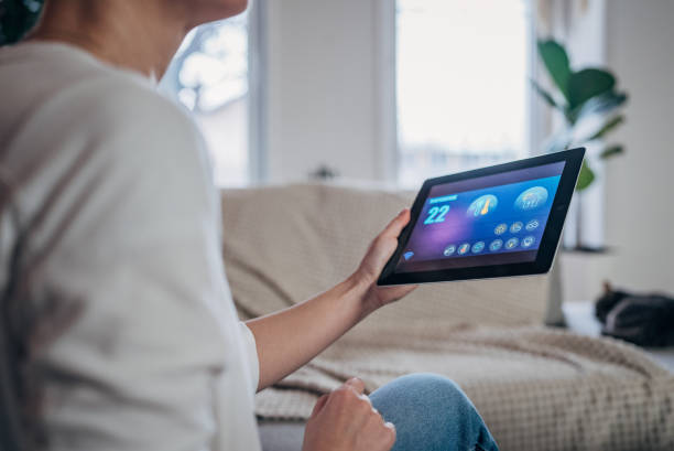 istock Woman using digital tablet to control smart devices at home 1937247219