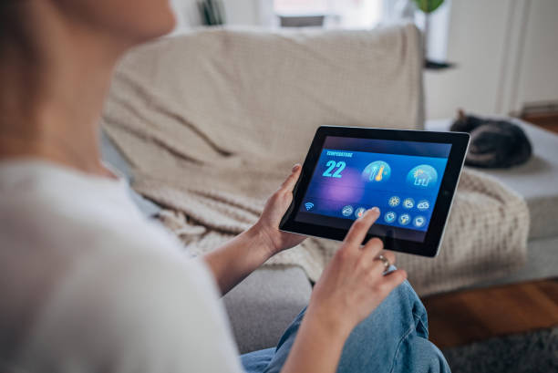 istock Woman using digital tablet to control smart devices at home 1937247800