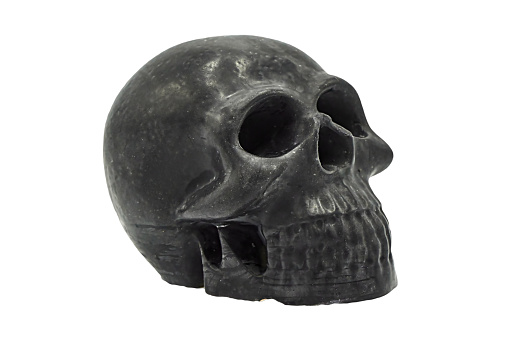 \nMetallic human skull over black , 3D illustration