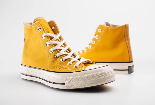 istock Yellow sneakers on white background with copy space. Youth shoes. 1937253200