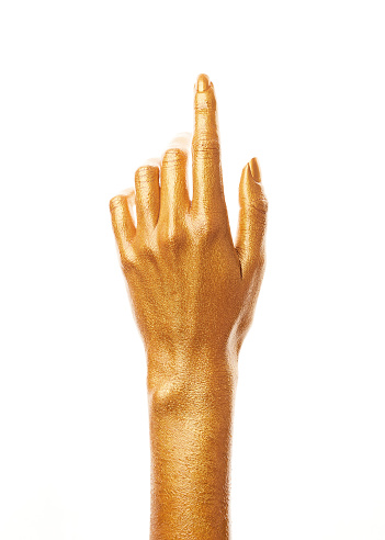 Hands in gold paint. Golden fingers. Female hand isolated on white background. White women's relaxed hand showing symbols and gestures.
