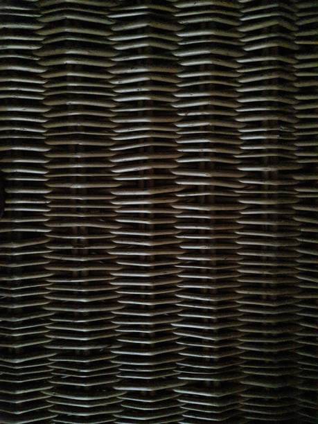 Wicker panel. Full frame. Wicker is a new, flexible wicker rod that, after being peeled and dried, is used to make furniture, baskets, etc. Its use dates back to at least Ancient Egypt (3200–30 BC), for the production of basketry; There are even examples of ceramics with decoration imitating wicker. wood and wire fence designs pictures stock pictures, royalty-free photos & images